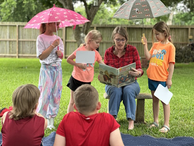 Dr. Jennifer Hardin reading to a group of children